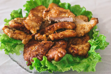 homemade grilled chops with lettuce leaves on the kitchen table.