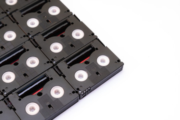 Vintage mini DV cassette tapes used for filming back in a day. Pattern made of small magnetic, plastic video tapes