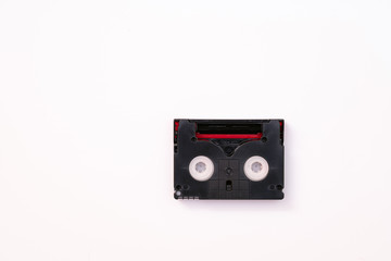 Vintage mini DV cassette tape used for recording video back in a day. Plastic, magnetic, analog film tape on white background