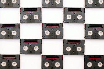 Obraz premium Vintage mini DV cassette tapes used for filming back in a day. Pattern made of plastic video tapes on white background