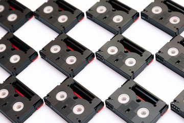 Vintage mini DV cassette tapes used for filming back in a day. Pattern made of plastic video tapes...