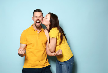 Happy young couple on color background