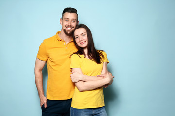 Happy young couple on color background