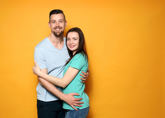 Fototapeta premium Happy young couple on color background