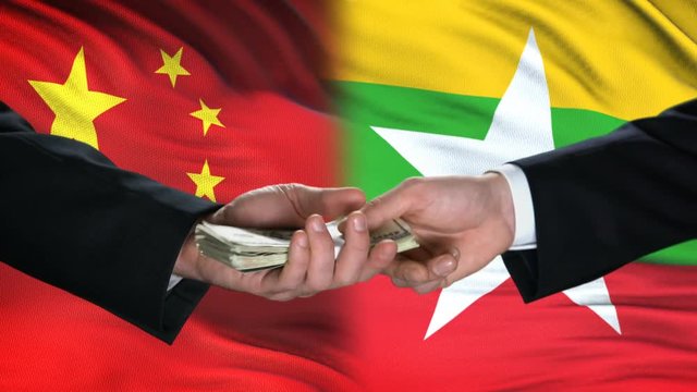 China and Myanmar officials exchanging tank money, arms trade, flag background