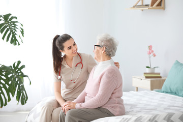 Doctor with senior woman in nursing home