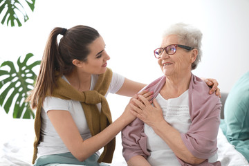 Caregiver with senior woman in nursing home