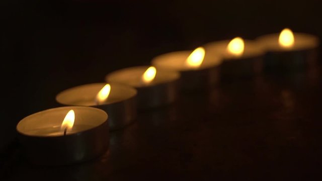 candles lit in a row in the church