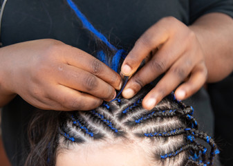 weaving thin braids on the head