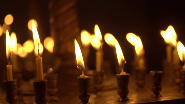 candles are lit on the candlestick in the church