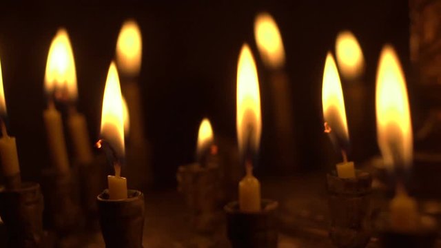 candles are lit on the candlestick in the church