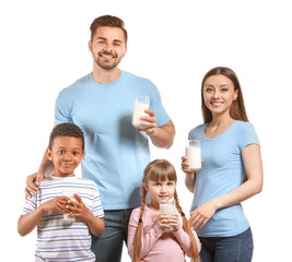 Young family with glasses of tasty milk on white background