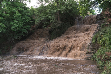 flood, cataclysm, high rainfall, the threat of flooding, dirty water. Dzhurinsky waterfall, Ukraine