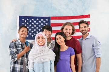 Group of students near wall with USA flag