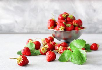 Colander with ripe red strawberry on table