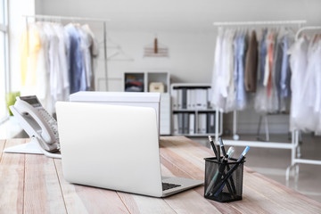 Laptop on table in modern dry-cleaner's