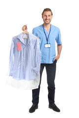 Male worker of modern dry-cleaner's on white background
