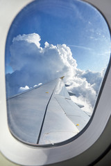 The window, wing, clouds