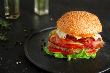 Tasty burger with bacon on plate