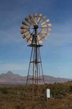 Large windmill for pumping ground water, standing tall in the dry Karoo of the southern Karoo of South Africa