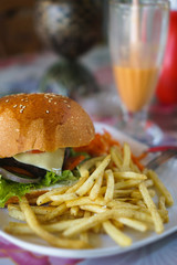 Burger and french fries on the table. Delicious food fast food. American food in a cafe