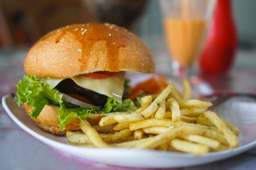 Burger and french fries on the table. Delicious food fast food. American food in a cafe