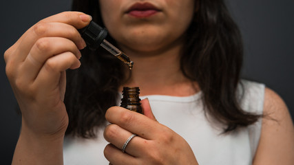 The young person uses hemp oil. Cannabis is a concept of herbal medicine.