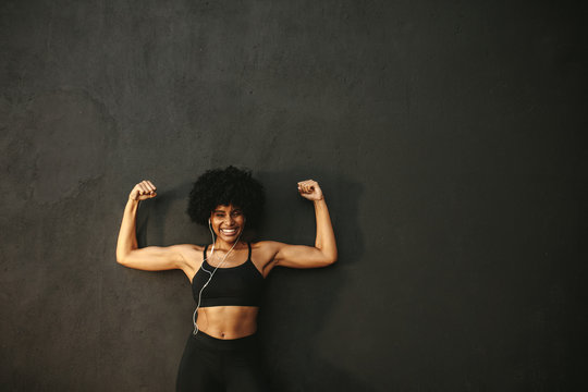 Smiling Athlete Flexing Muscles