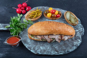 Traditional Turkish cuisine: Special bread meat doner kebab on background wooden. (doner meat on...