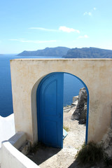 Santorini oia thira seascape with open blue door of property. Serenity mediterranean greek scene....