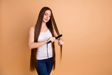 Close up photo beautiful amazing her she lady arms hands hold very long hair curl straightening enjoy easy simple process wear casual white tank-top jeans denim isolated pastel beige background