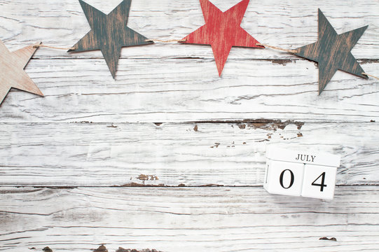 Fourth of July Background. Wooden stars and wood calendar blocks with the date July 4th to mark America's Independence Day. 