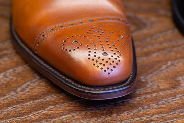 brown brogue toe of men full grain leather shoe, close up