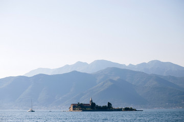 Adriatic Sea, Montenegro. View of a small church on the island of St. George in the Bay of Kotor, view from a boat, Montenegro. Place for text.