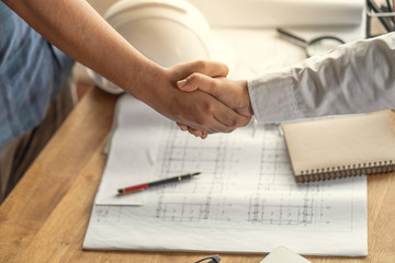 Customers handshake agreement with the contractor for construction of houses