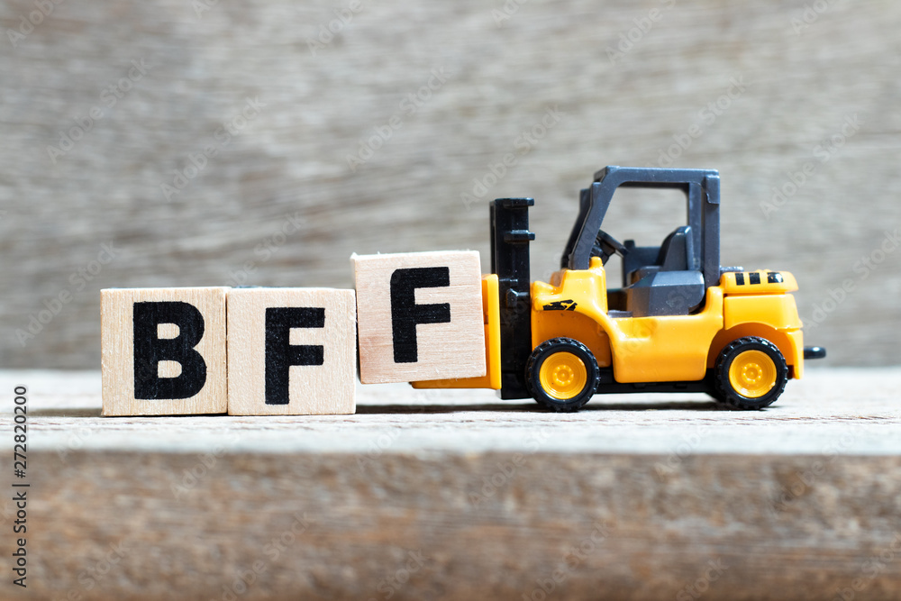 Poster Toy forklift hold letter block f to complete word BFF (Abbreviation of best friend forever) on wood background