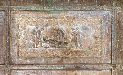 Bas-relief with scenes from the Bible on the massive decorated front door  at the entrance to Tabgha - Catholic Church Multiplication of bread and fish