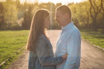 Fototapeta premium A young couple spends time together outdoors. Couple having fun summer time