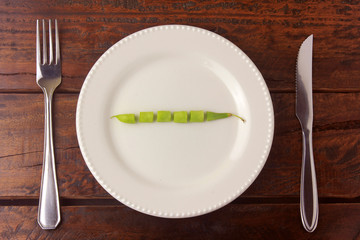 Concept of calorie restriction. Strict diet. Small bunch of American broccoli isolated on white...