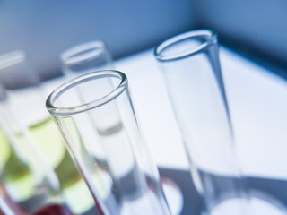 Multiple test tubes packed with chemicals, close-ups, background