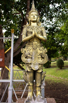 Angel brass statue in garden of Phra That Nadoon Chedi or Na Dun Pagoda for thai people travel visited and respect praying at Mahasarakham city in Maha Sarakham, Thailand