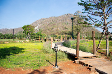 Fototapeta na wymiar View landscape and mountain with wooden walkway for thai people travel visit and take photo at Nakhon Ratchasima, Thailand