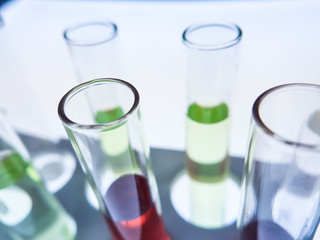 Multiple test tubes packed with chemicals, close-ups, background