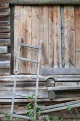 fragment of old wood building with closed door into barn and  wood stair
