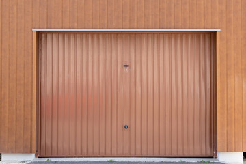 Brown metal closed shutter door of modern garage