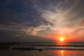 Nature in twilight period, Sunrise or Sunset over the sea with beach. Sea view from tropical beach with purple and orange sky. Vintage retro sea scape.