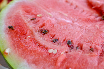 Red watermelon in the cut with seeds at summer