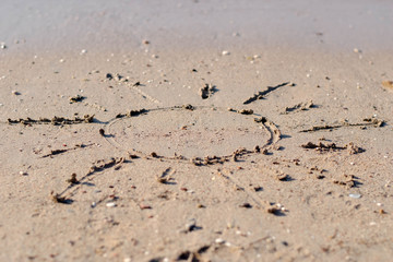 Top view of sandy beach with symbol and copy space
