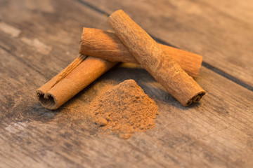 cinnamon sticks on the wooden table and cinnamon powder
