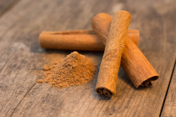 cinnamon sticks on the wooden table and cinnamon powder